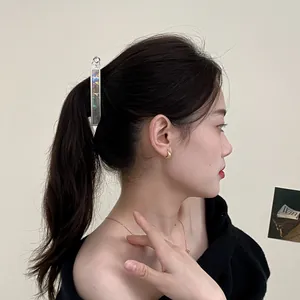 Iridescent rectangular hair clip on model featuring shell texture and gold finish
