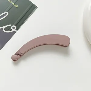 Detail view of large matte banana hair clip in dusty pink with anti-slip curved design