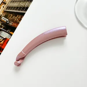 Detail view of pink glitter banana clip with elegant twist design and pearl finish