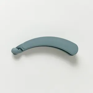 Detail shot of the matte finish and curved design on this large blue banana hair clip