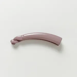 Close-up of a small glossy lavender banana hair clip with curved resin design