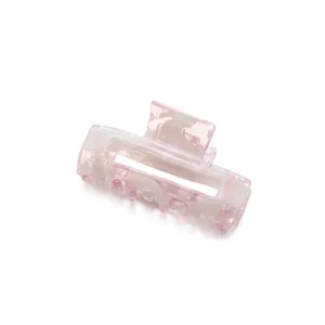 Pink floral acetate rectangular hair claw clip with a marble texture on white background