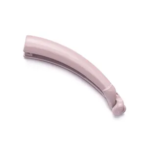 Glossy banana hair clip in dusty pink with minimalist twist design on white background