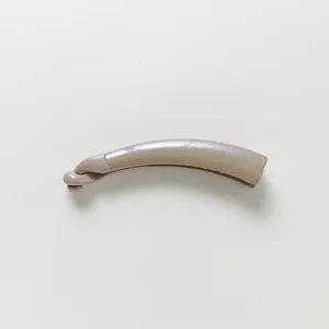 Close-up of a nude glitter banana hair clip with a pearlescent finish and minimalist design
