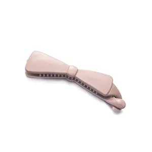 Glossy nude pink banana hair clip with bow design and inner teeth for thick hair