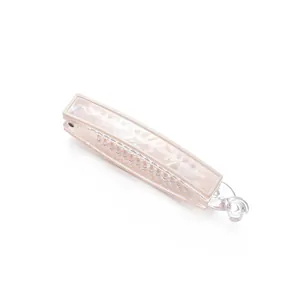 Beige banana hair clip with iridescent marble texture finish and secure twist lock