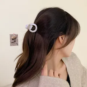 Minimalist cream white round hair claw clip for elegant half-up hairstyles on women