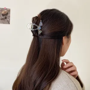 Transparent heart hair claw clip with rhinestones on brunette hair half-up hairstyle