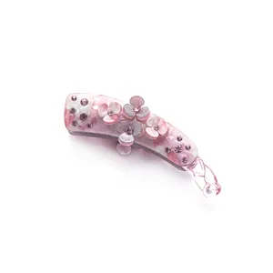 Pink banana hair clip with marble resin texture, three floral petals and sparkling rhinestones