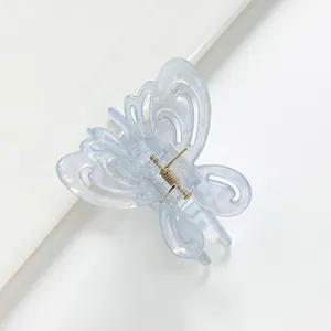 Detailed close-up of light blue hollow butterfly hair claw with iridescent finish
