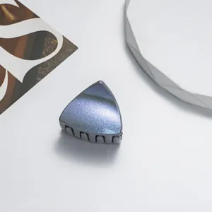 Detail view of mini glitter cat ear hair claw clip with iridescent blue finish