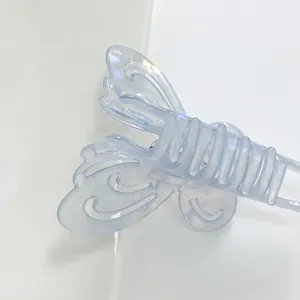 Close-up of light blue frosted butterfly hair claw clip with metallic spring detail