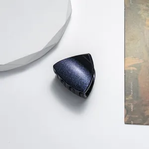 Deep blue glitter triangular hair claw clip detail with a star-like shimmering finish