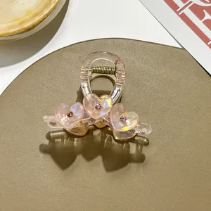 Detail of iridescent heart hair claw with pink rhinestones and strong metal spring