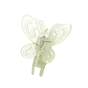 Detailed view of hollow butterfly hair claw clip with pearlescent finish and metal spring