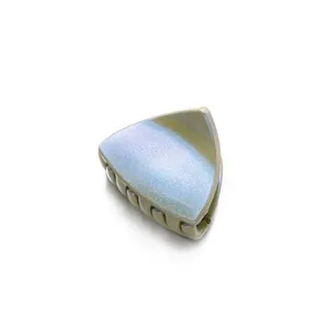 Macro detail of triangle hair claw clip with iridescent glitter finish and green inner teeth