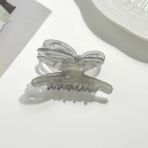 Detail of a translucent smoke grey butterfly hair claw clip for elegant hairstyles