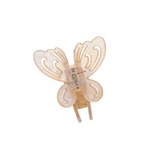 Hollow butterfly hair claw clip with pearlescent cream finish and secure metal spring