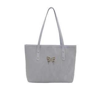 Light blue pleated tote bag with silver butterfly accent and metallic stud handles