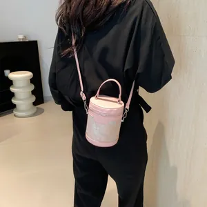 Elegant pink floral cylinder crossbody bag with top handle and adjustable strap for women