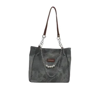 Grey vintage shoulder bag with brown straps, metallic chain and pearl accents