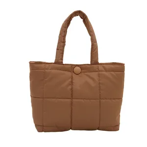 Brown quilted puffer tote bag with square stitching and padded handles for women