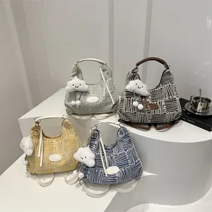 Four colorful plaid tote bags in green, brown, yellow, and blue with cloud charms