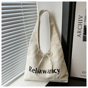 Chic beige canvas hobo bag with Reliawancy print and delicate bow decoration