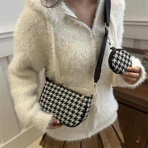 Houndstooth crossbody bag with mini coin purse shown on model for a casual look