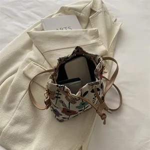 Ethnic style floral jacquard bucket bag with leather drawstring and spacious interior