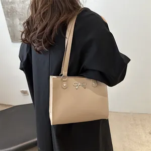 Chic beige tote bag with silver butterfly charm for women shoulder or underarm carry