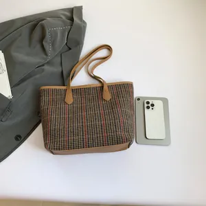 Retro plaid tote bag with brown leather handles and woven texture for autumn winter fashion