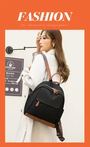 Detail of stylish two-tone oxford backpack with brown leather base shown on a model