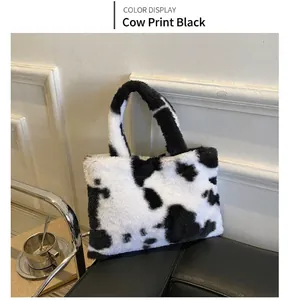 Detail of plush black and white cow print handbag on a stylish black leather sofa