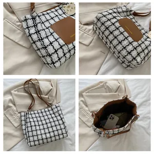Détail du sac cabas pied-de-poule noir et blanc avec poignées en cuir marron et intérieur