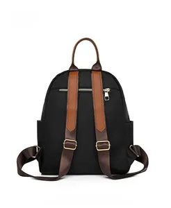 Detail view of the backpack back featuring a hidden zipper pocket and adjustable straps
