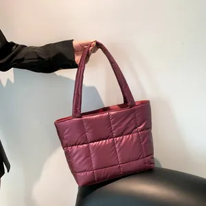 Deep magenta quilted puffer tote bag with glossy nylon finish and long shoulder handles