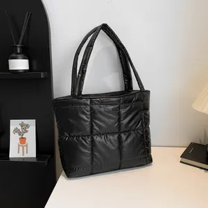 Minimalist black quilted puffer tote bag for women with glossy finish and large capacity