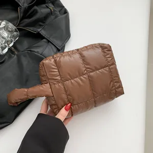 Minimalist coffee brown quilted puffy handbag with soft nylon texture and padded handle