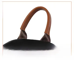 Detail of reinforced brown textured handle and black oxford fabric on the commute backpack