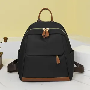 Chic black nylon backpack with brown leather trim for women's stylish commuting needs