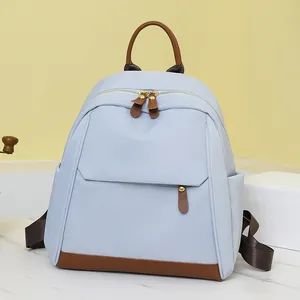 Light blue oxford fabric commute backpack with leather trim and gold hardware accents