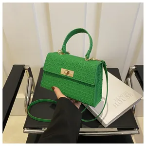Vibrant green woven texture crossbody bag with gold twist lock and top handle