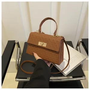 Brown woven texture crossbody handbag with gold metal lock and top handle for women