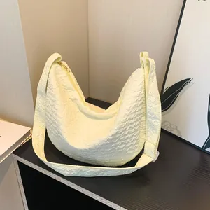 Minimalist light yellow hobo bag with bubble texture fabric and shoulder strap
