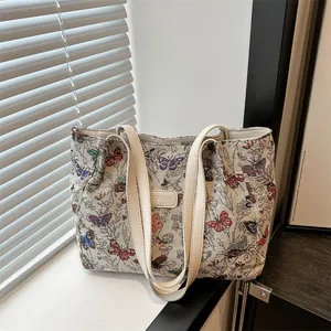 Vintage canvas tote bag featuring butterfly floral jacquard print and dual shoulder straps
