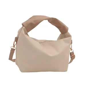 Minimalist cream shoulder bag with khaki knot handle and adjustable strap for women
