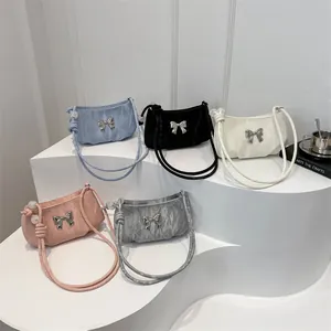 Pleated underarm bags in five colors with silver bow decor and beaded straps