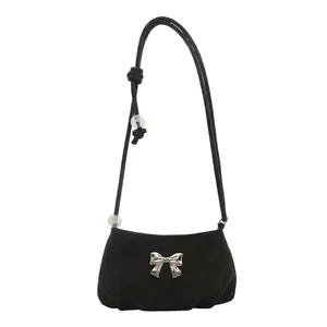 Minimalist black suede crossbody bag with silver butterfly buckle and beaded strap