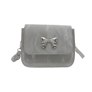 Gray butterfly crossbody mini bag with crinkled texture and silver metallic bow detail